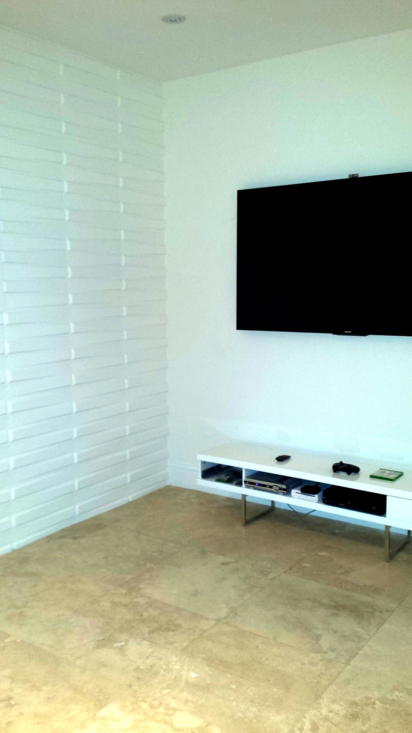 Living room wall with white dimensional 3D panels