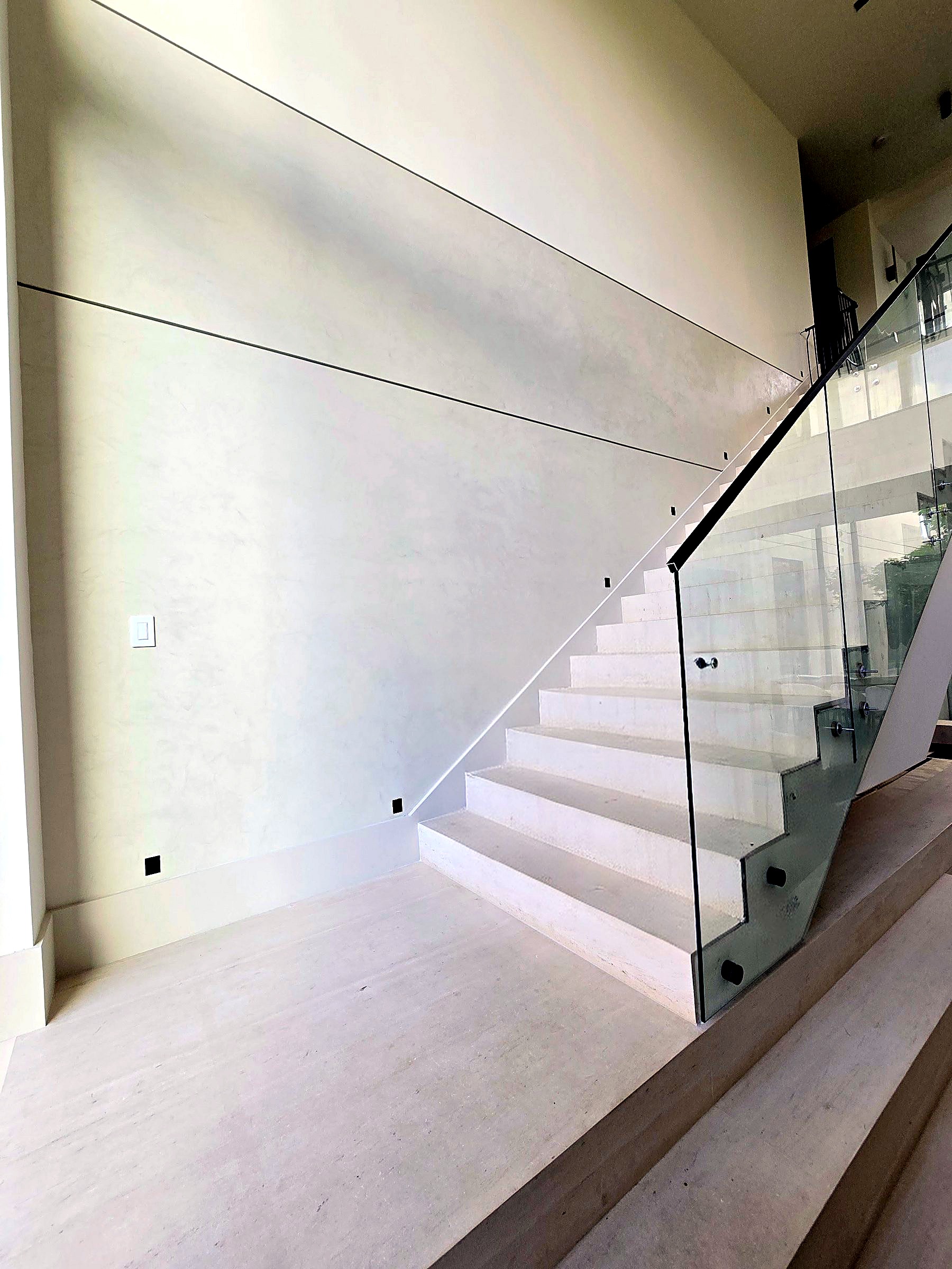 Stair hall with hand-troweled Roman clay walls