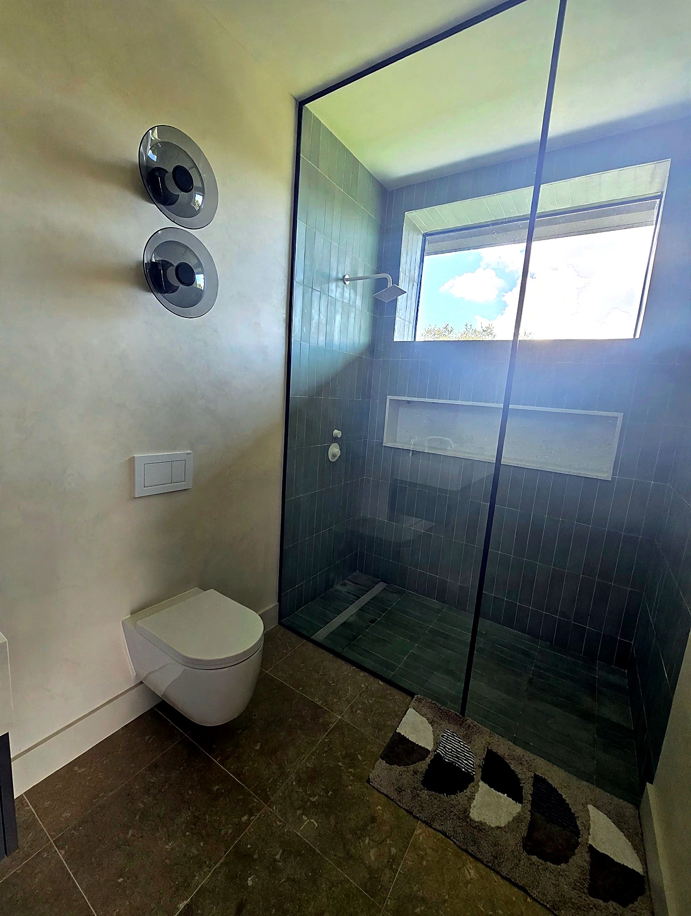Bathroom with Venetian plaster walls and a glass-enclosed shower