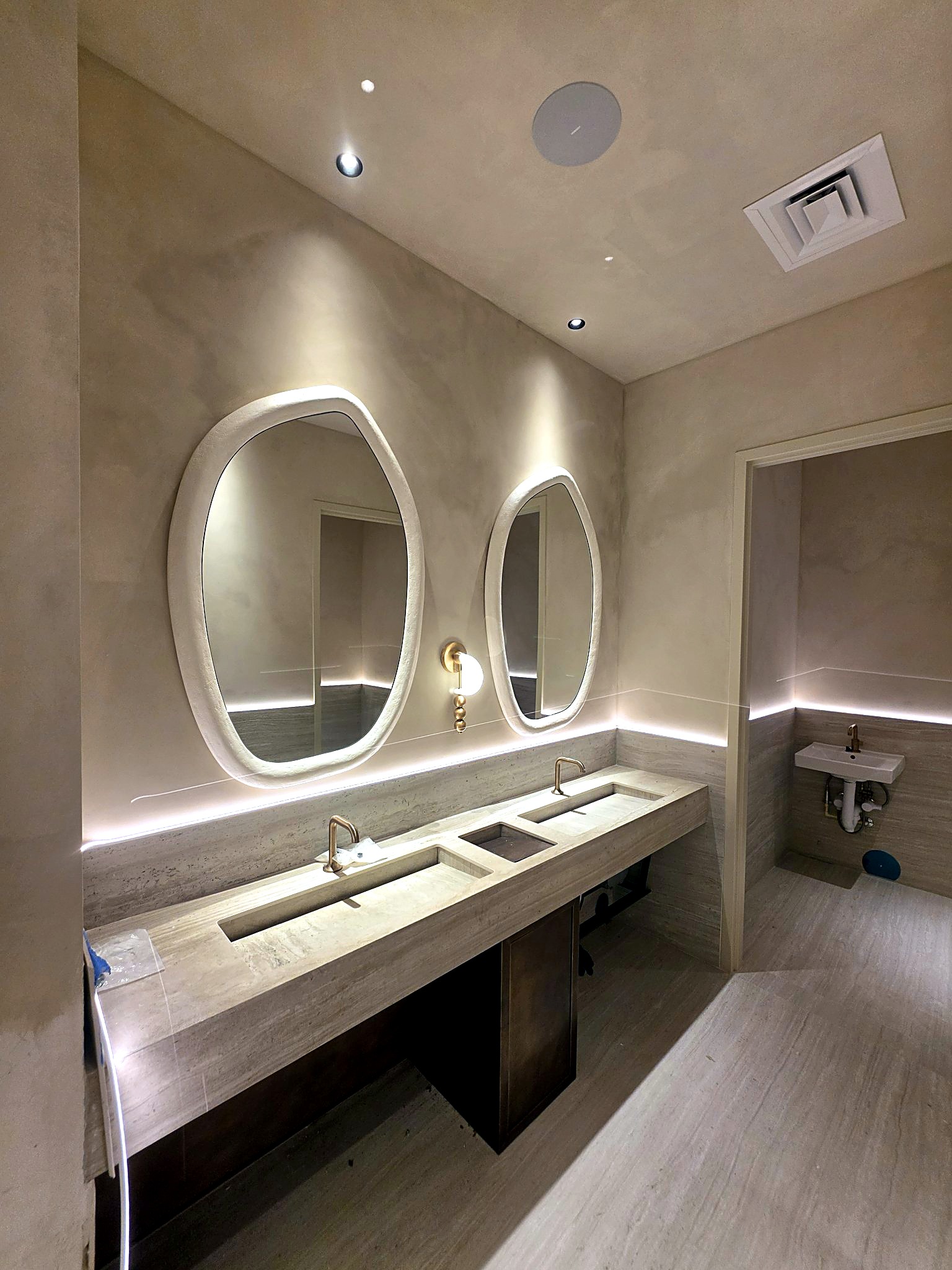 Completed bathroom vanity with softly layered finished walls